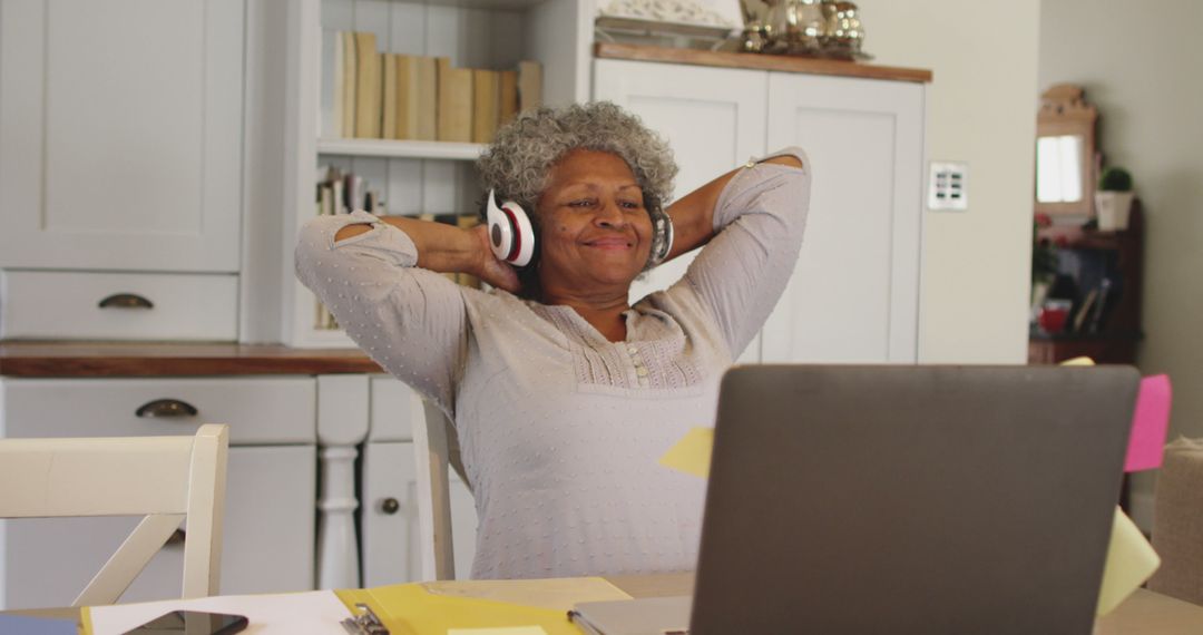 Elderly Woman Relaxing with Headphones at Home Office - Free Images, Stock Photos and Pictures on Pikwizard.com