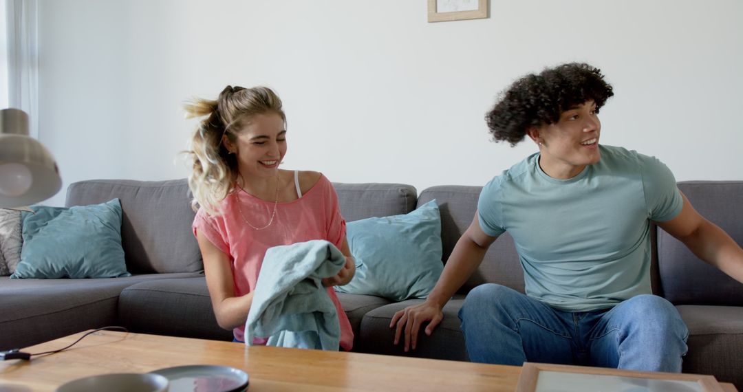 Young Couple Relaxing Together on Sofa Enjoying Quality Time