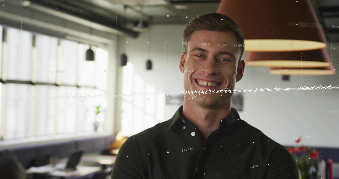 Smiling professional in open-plan office with digital data overlay and teamwork energy