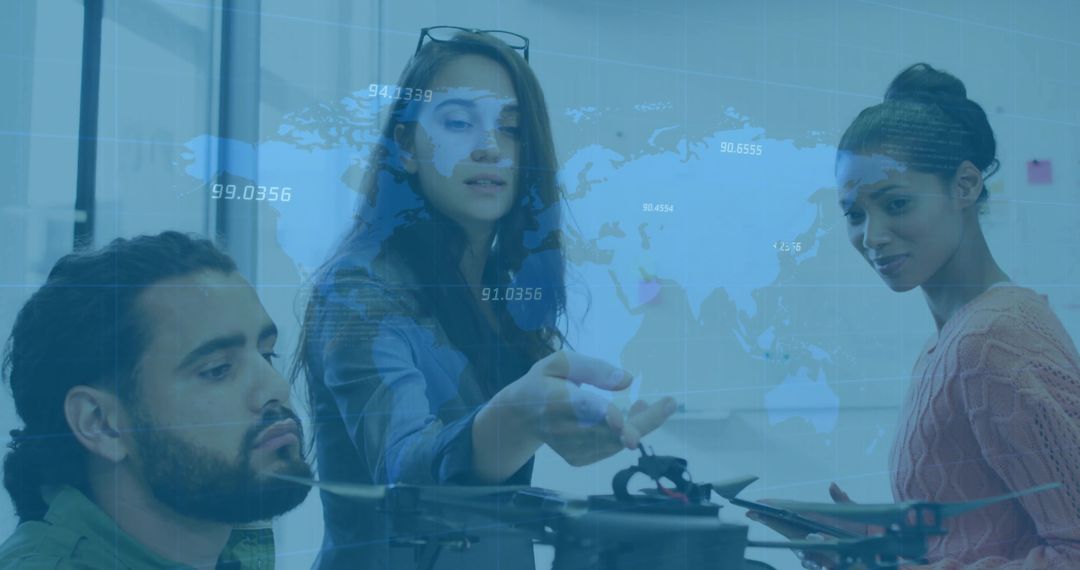 Team Analyzing Drone Model with World Map Overlay in Tech Lab