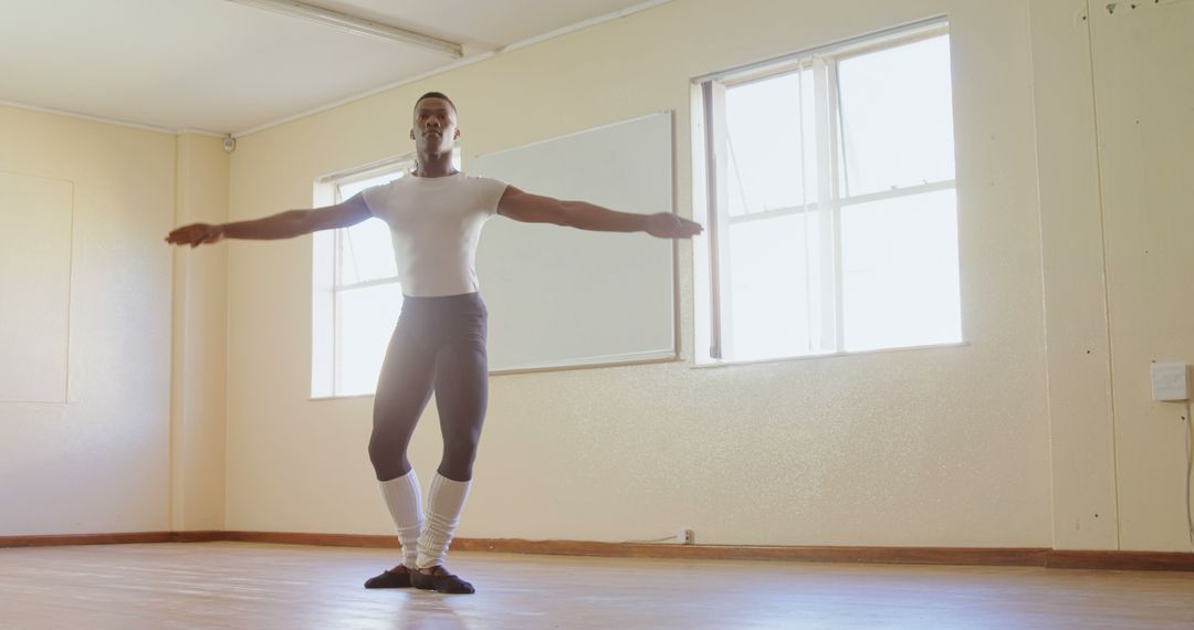 Male Ballet Dancer Practicing in Sunlit Studio - Free Images, Stock Photos and Pictures on Pikwizard.com