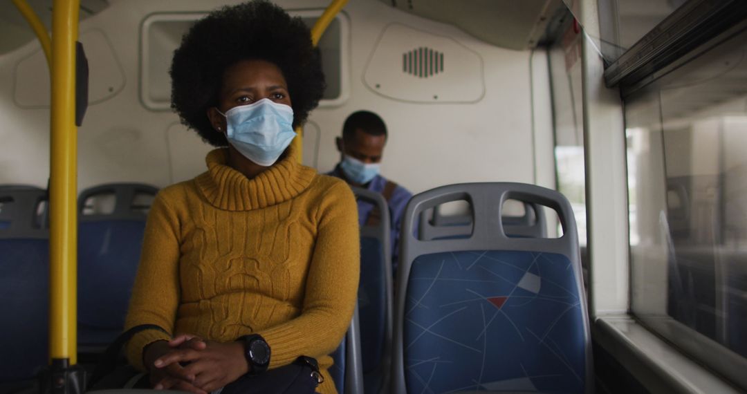 Individuals with Face Masks Riding Bus During Pandemic
