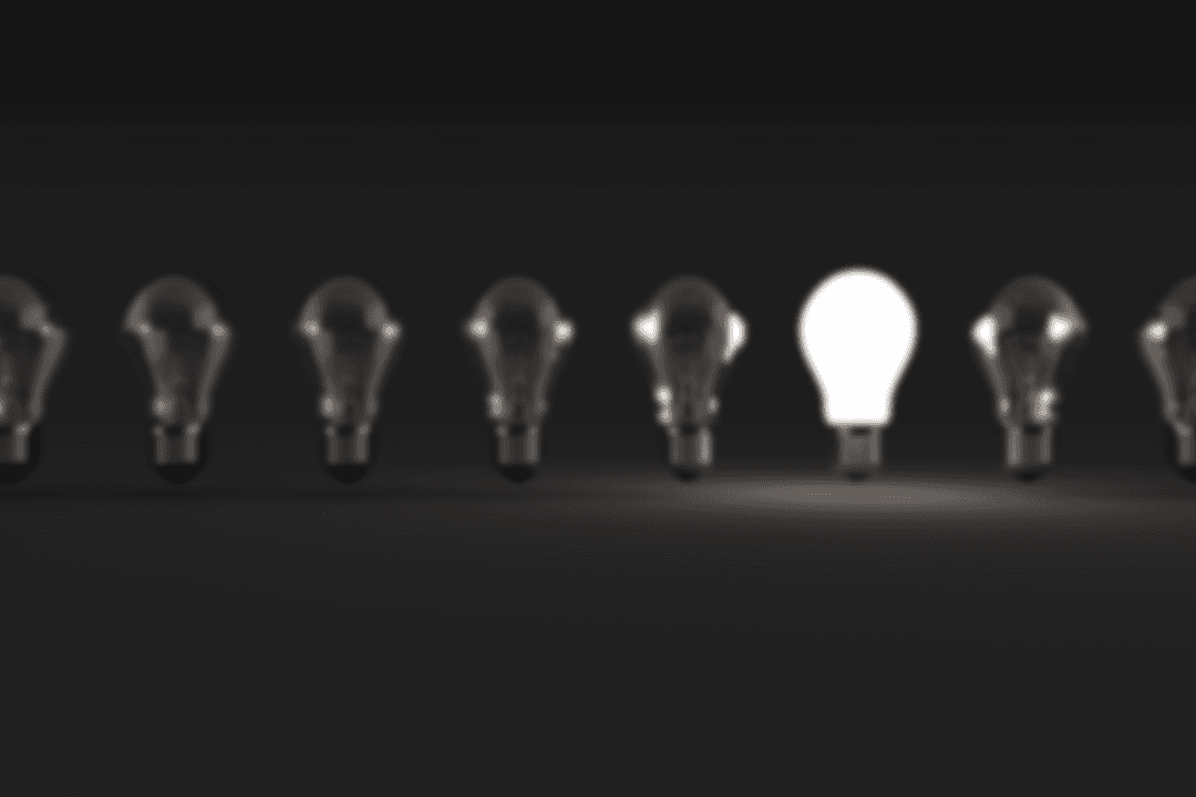 Transparent Light Bulb in Dark Row Inspiration Concept