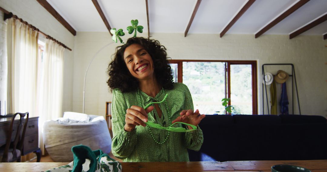 Smiling Woman Celebrating St. Patrick's Day at Home with Decorations - Free Images, Stock Photos and Pictures on Pikwizard.com