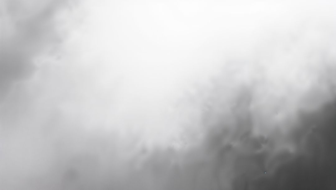 Monochrome Clouds Forming Luminous Center with Shadowed Lower-Right Depth