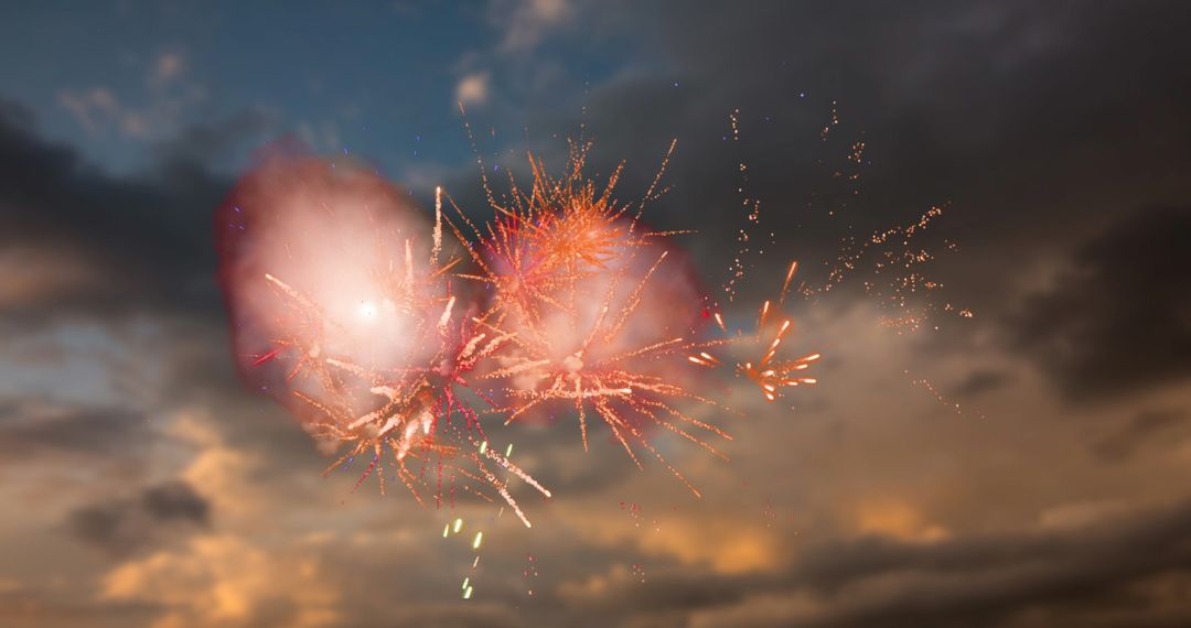 Vibrant Red Fireworks Exploding Amidst Cloudy Sunset Sky