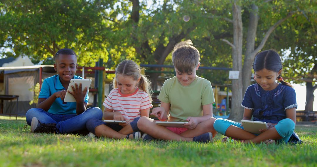 Diverse Group of Children Learning with Tablets Outdoors - Free Images, Stock Photos and Pictures on Pikwizard.com