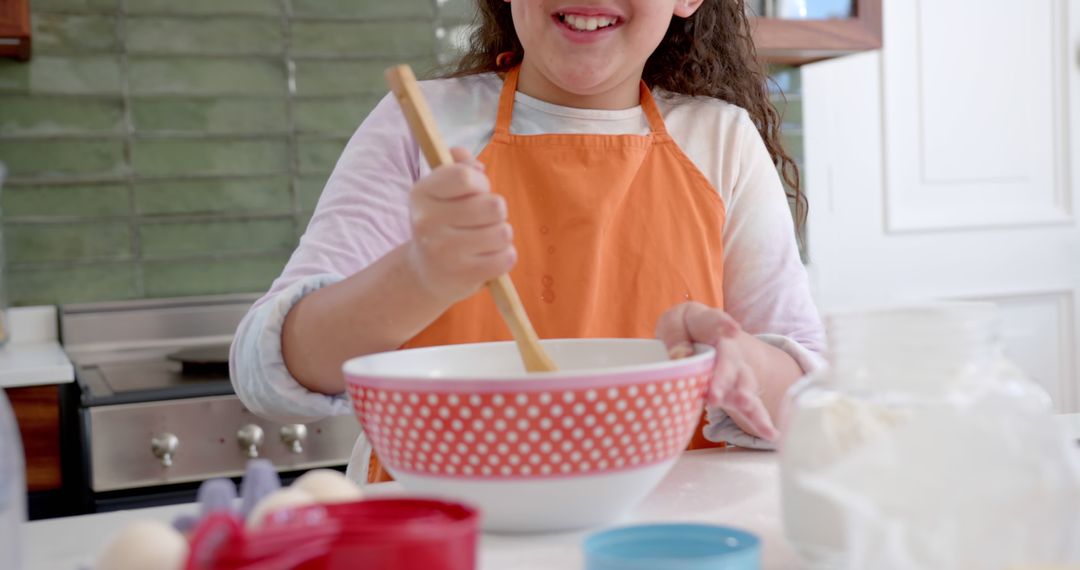 Happy Child Mixing Ingredients in Kitchen - Free Images, Stock Photos and Pictures on Pikwizard.com