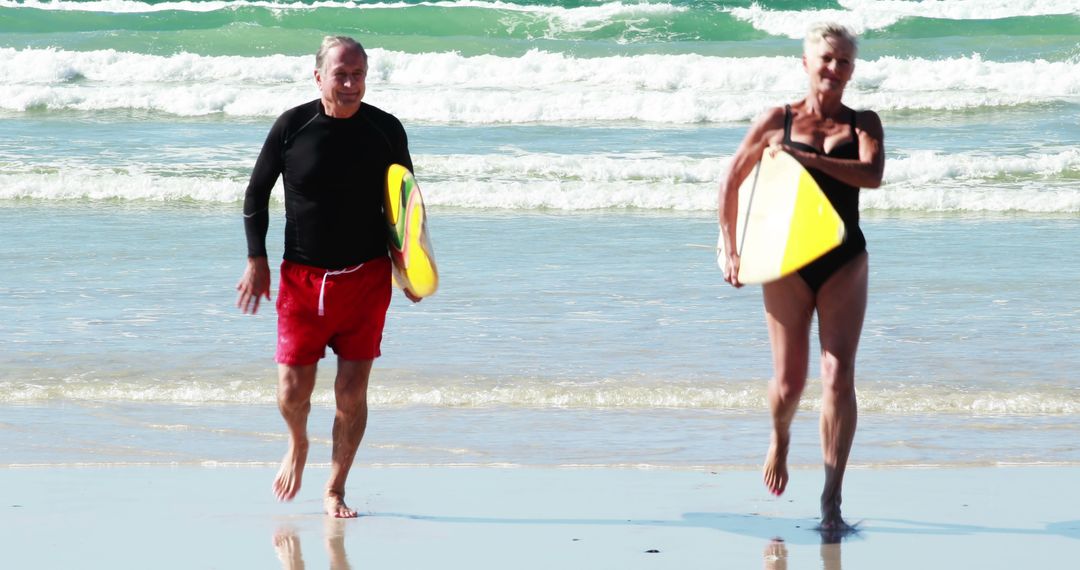 Senior Couple Enjoying Beach Activities with Surfboards - Free Images, Stock Photos and Pictures on Pikwizard.com