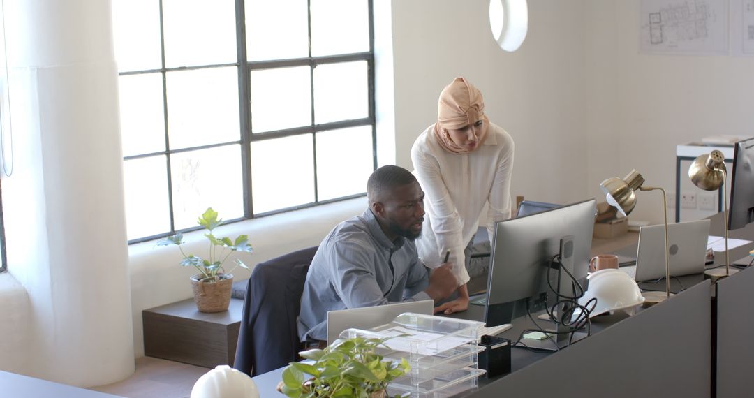 Colleagues Collaborating on Office Project at Computer Desk