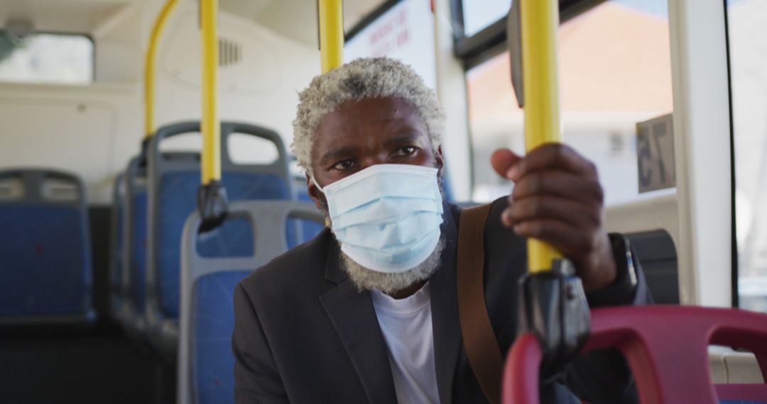 African american senior man wearing face mask travelling in the bus - Free Images, Stock Photos and Pictures on Pikwizard.com