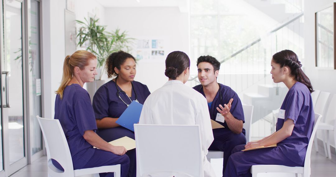 Image of diverse group of male and female doctors sitting in discussion in hospital meeting - Free Images, Stock Photos and Pictures on Pikwizard.com