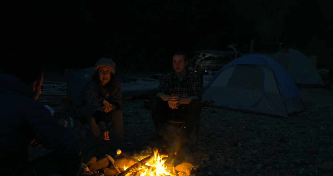 Friends Enjoying Evening Campfire Outdoors in Remote Wilderness - Free Images, Stock Photos and Pictures on Pikwizard.com