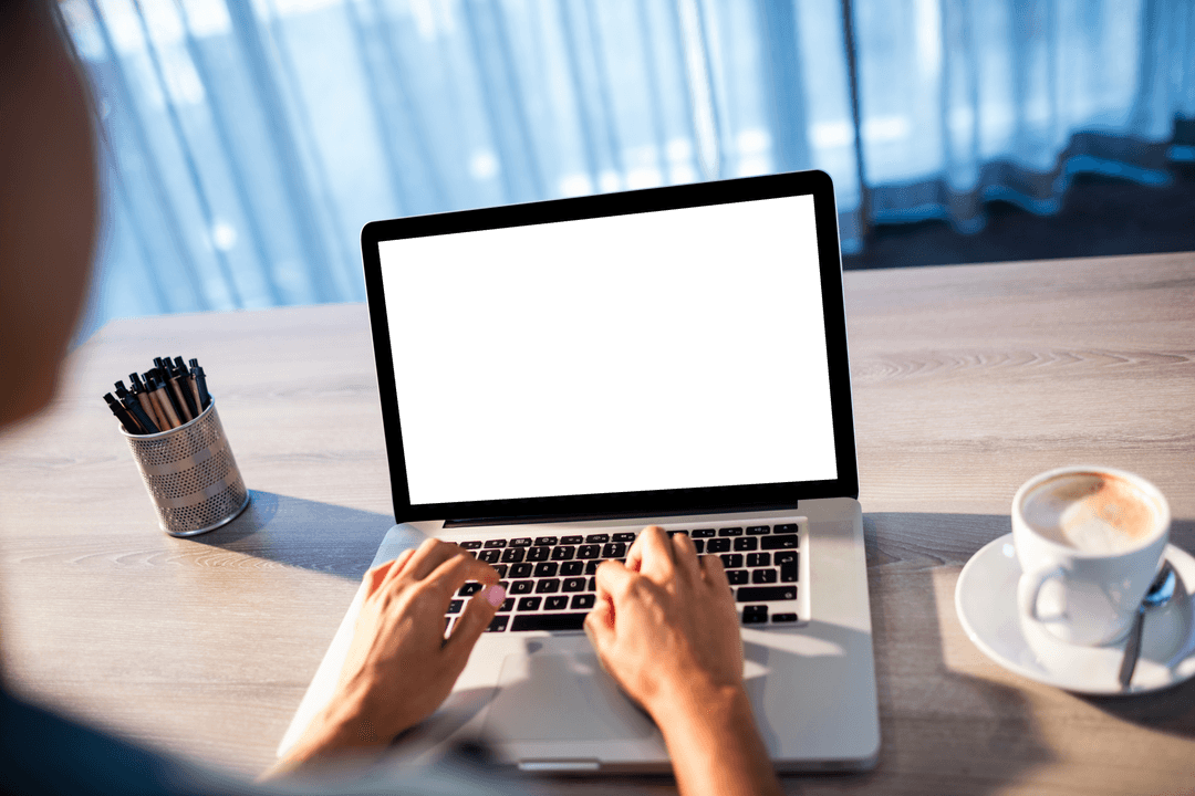Person Using Laptop with Transparent Blank Screen Near Coffee
