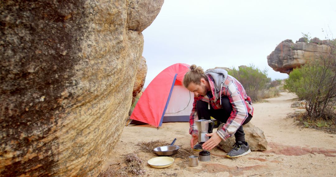 Man Preparing Coffee at Campsite in Rocky Desert - Free Images, Stock Photos and Pictures on Pikwizard.com