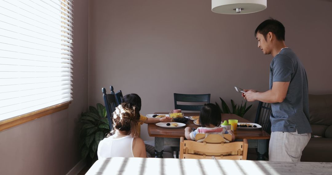 Family Dining Experience with Modern Technology Interaction