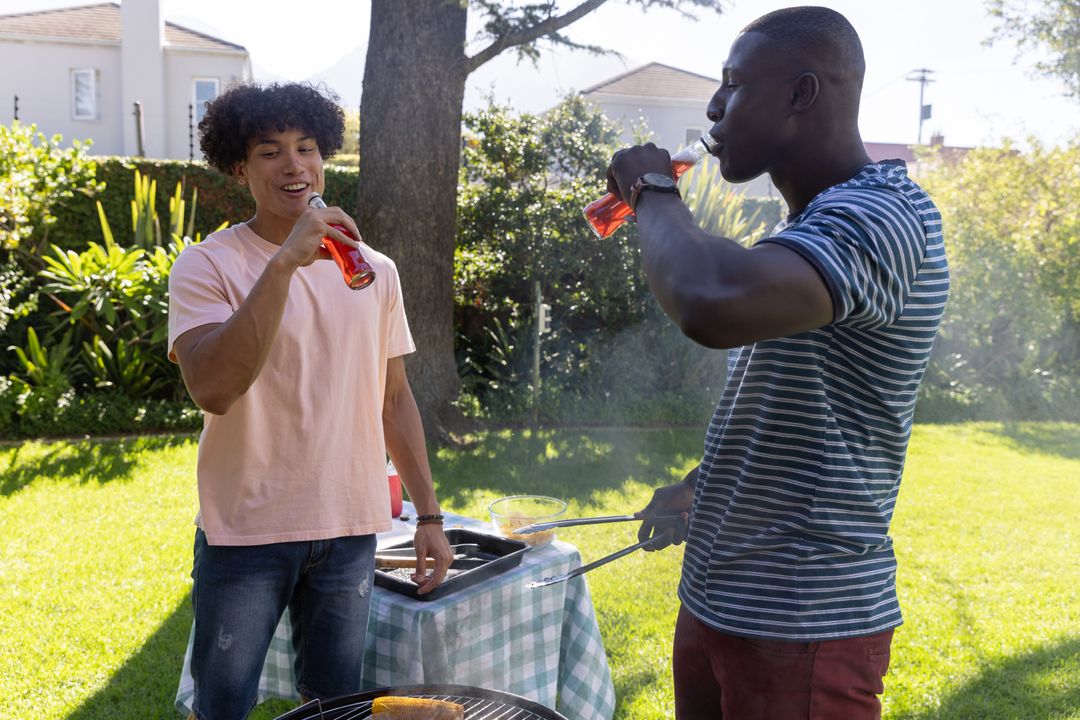 Friends Enjoying Barbecue and Refreshments in Backyard Gathering