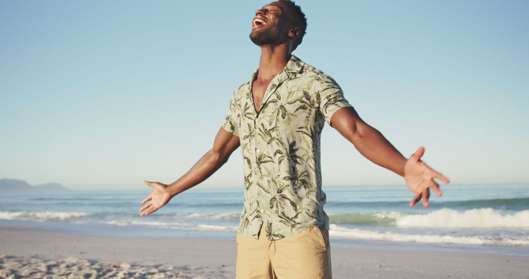 Joyful African American Man Celebrating Freedom on Beach - Free Images, Stock Photos and Pictures on Pikwizard.com