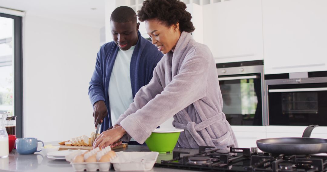 Image of happy african american couple preparing breakfast together in kitchen - Free Images, Stock Photos and Pictures on Pikwizard.com