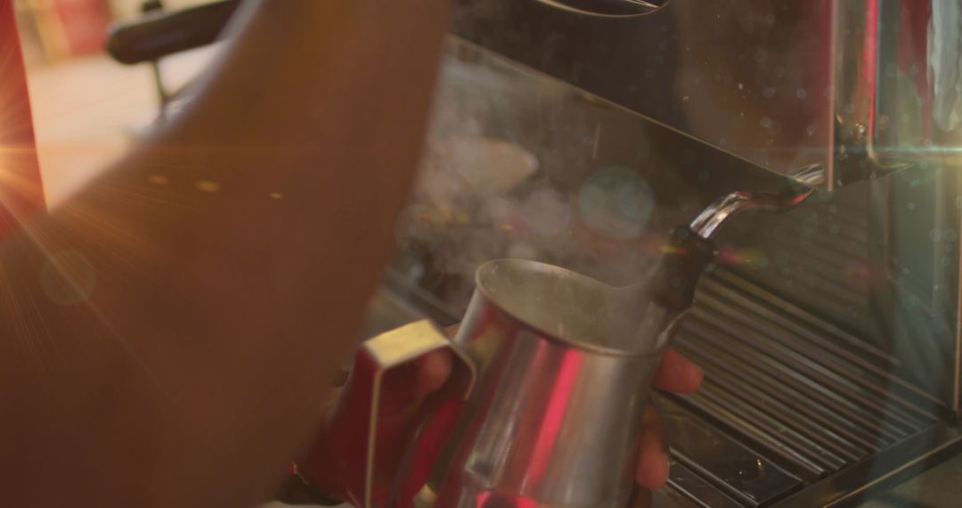 Barista Frothing Milk with Steaming Machine at Cafe