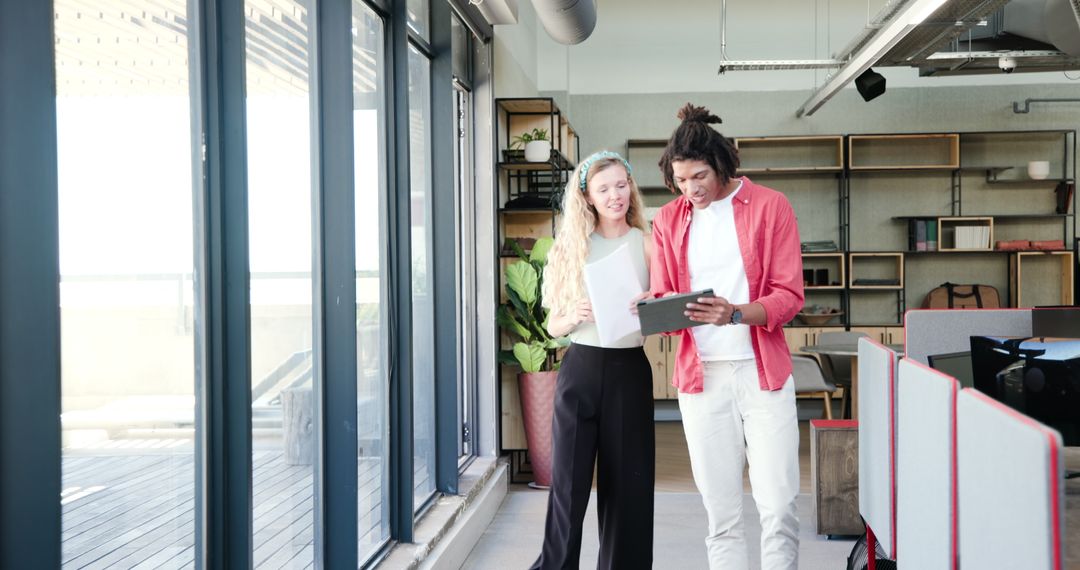 Colleagues collaborating in modern open office space