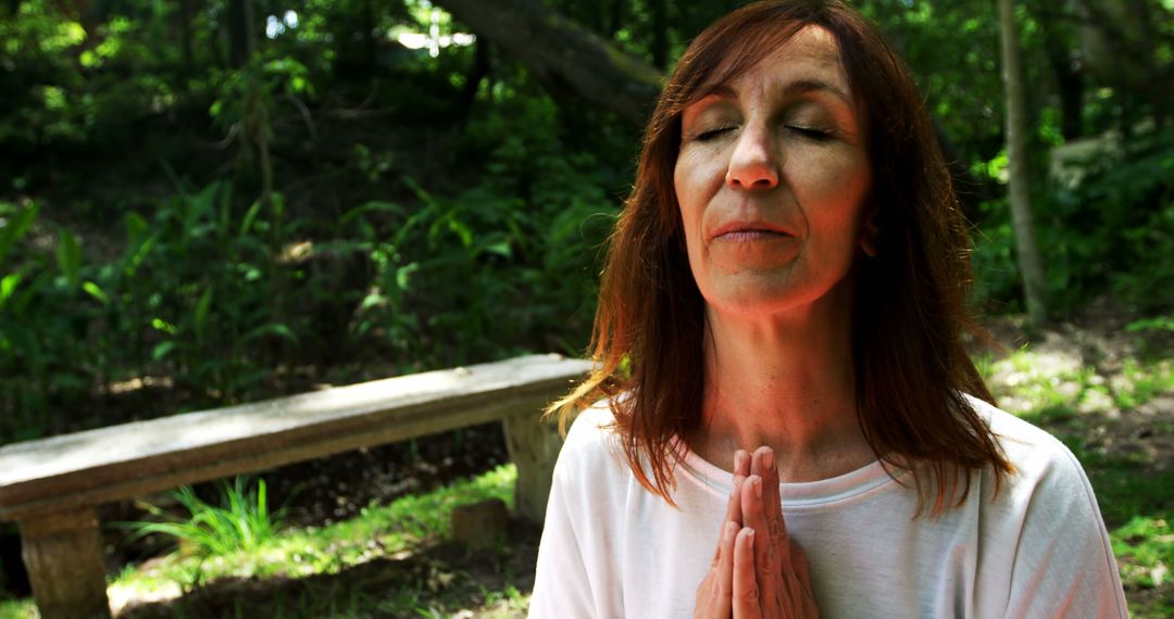 Mature Woman Meditating in Serene Forest Setting - Free Images, Stock Photos and Pictures on Pikwizard.com