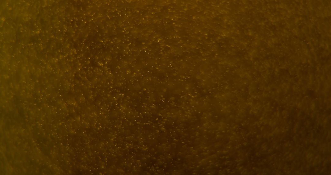 Close-Up of Beer Bubbles in Glass, Textured Abstract Background