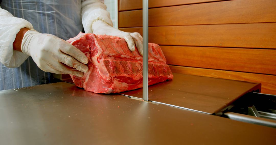 Butcher Slicing Large Beef Cut in Modern Butcher Shop - Free Images, Stock Photos and Pictures on Pikwizard.com