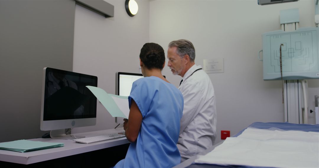 Surgeon and Nurse Reviewing Patient Reports on Computer - Free Images, Stock Photos and Pictures on Pikwizard.com