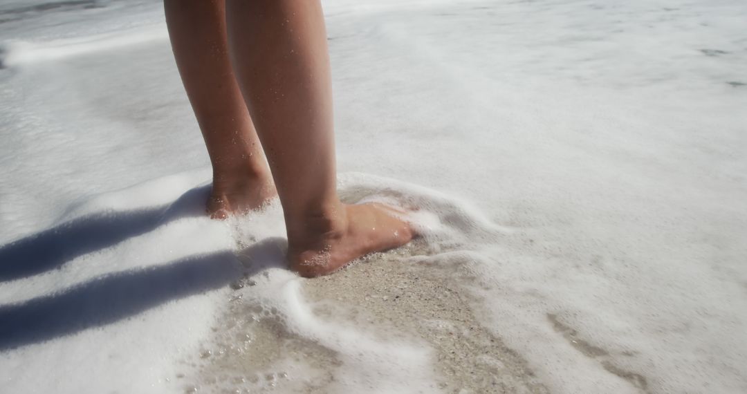 Close-Up of Bare Feet in Ocean Waves at Beach - Free Images, Stock Photos and Pictures on Pikwizard.com