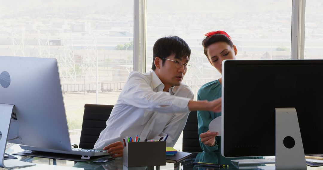 Business Professionals Collaborating at Desk with Computer