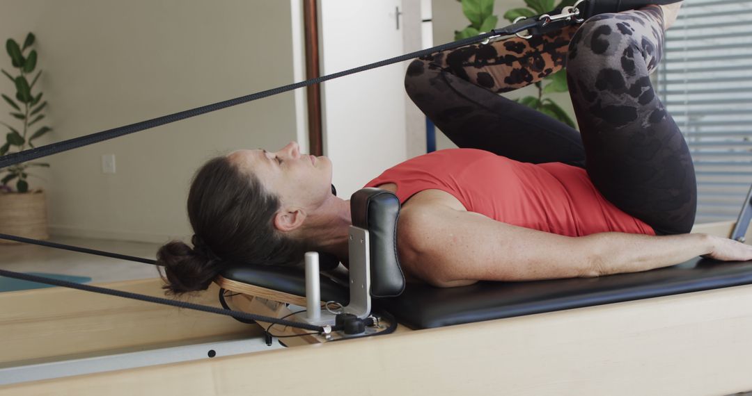 Woman Exercising on Pilates Reformer at Home - Free Images, Stock Photos and Pictures on Pikwizard.com