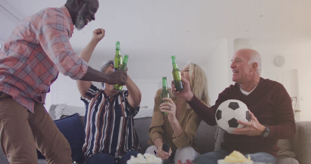 Friends Cheering with Beers Watching Soccer Match at Home