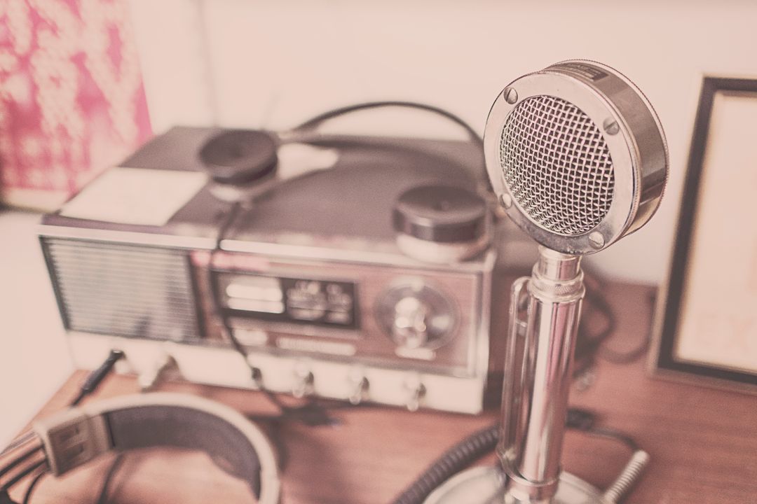 Vintage Microphone and Radio on Wooden Desk
