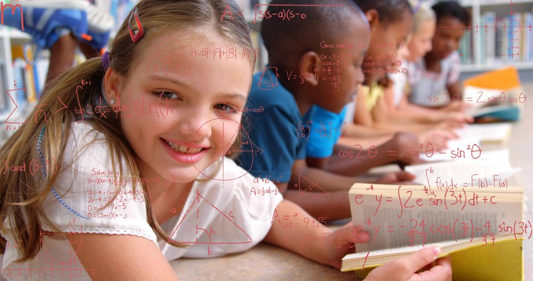 Smiling girl reading book on classroom carpet with classmates studying math formulas and collaborati