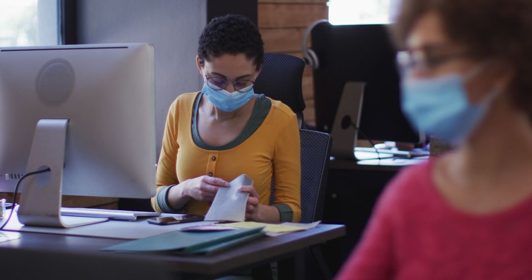 Employees Wearing Masks Working in Office during Pandemic - Free Images, Stock Photos and Pictures on Pikwizard.com