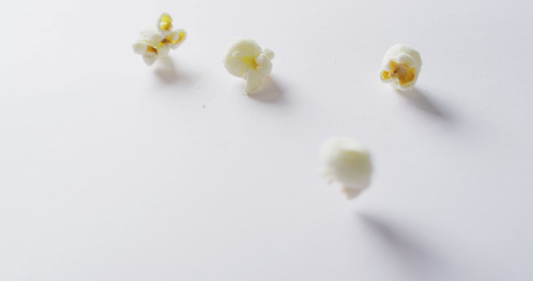 Scattered Popcorn on Minimalistic White Background