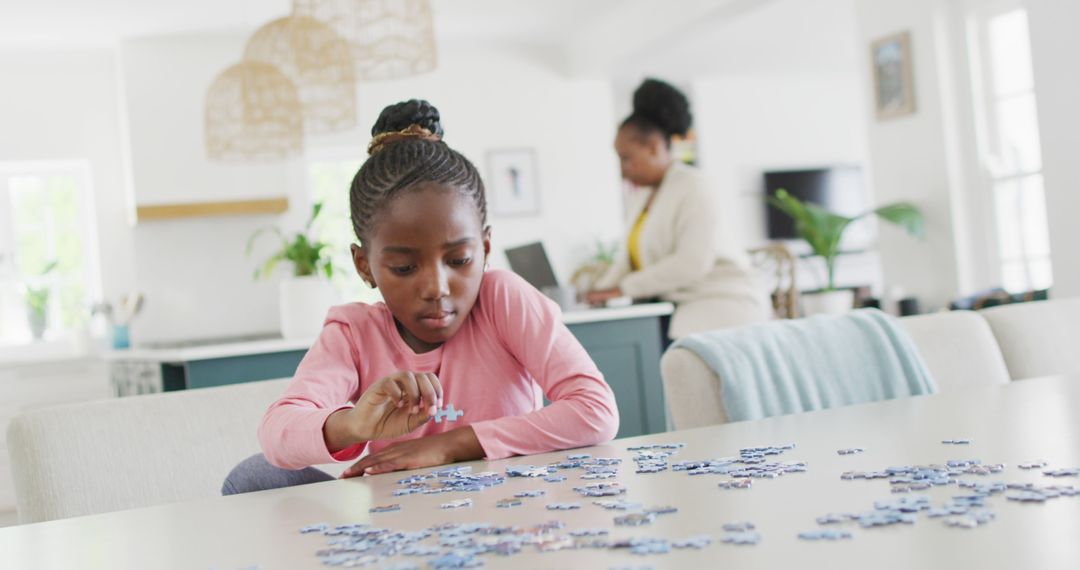 Focused Young Girl Solving Puzzle on Table in Modern Home - Free Images, Stock Photos and Pictures on Pikwizard.com