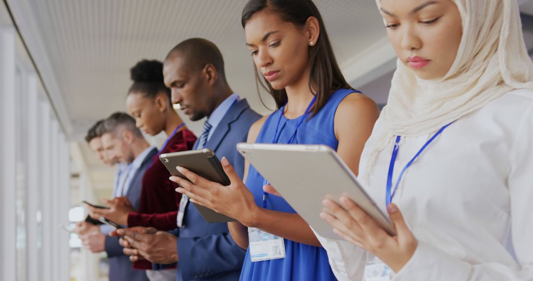 Diverse Professionals Using Tablets in Modern Office