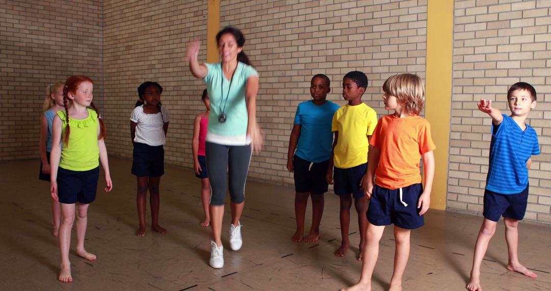 Energetic Kids in Gym Class with Enthusiastic Instructor - Free Images, Stock Photos and Pictures on Pikwizard.com