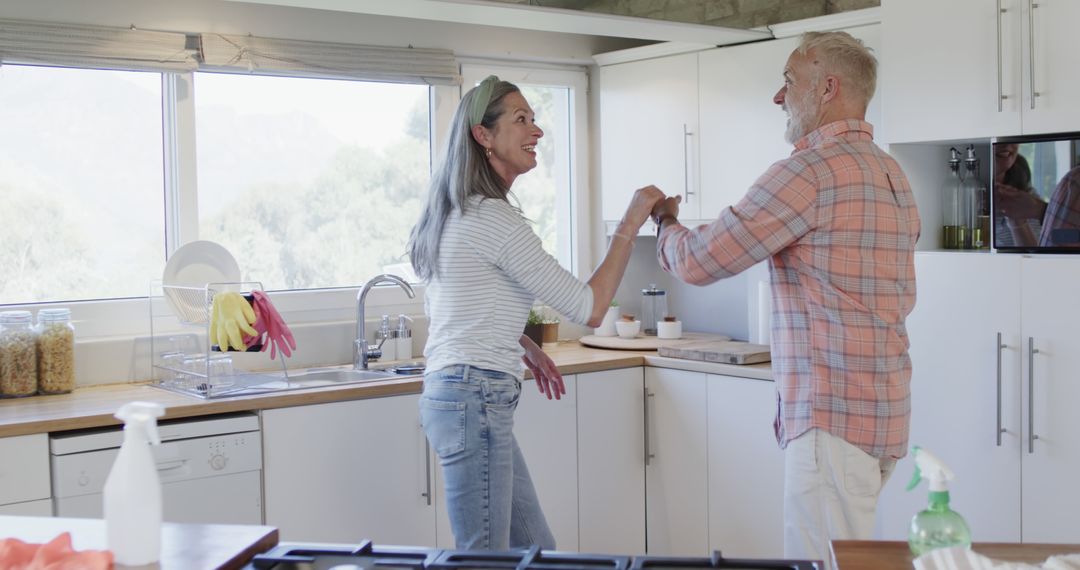 Senior Couple Enjoying Dance in Bright Kitchen - Free Images, Stock Photos and Pictures on Pikwizard.com