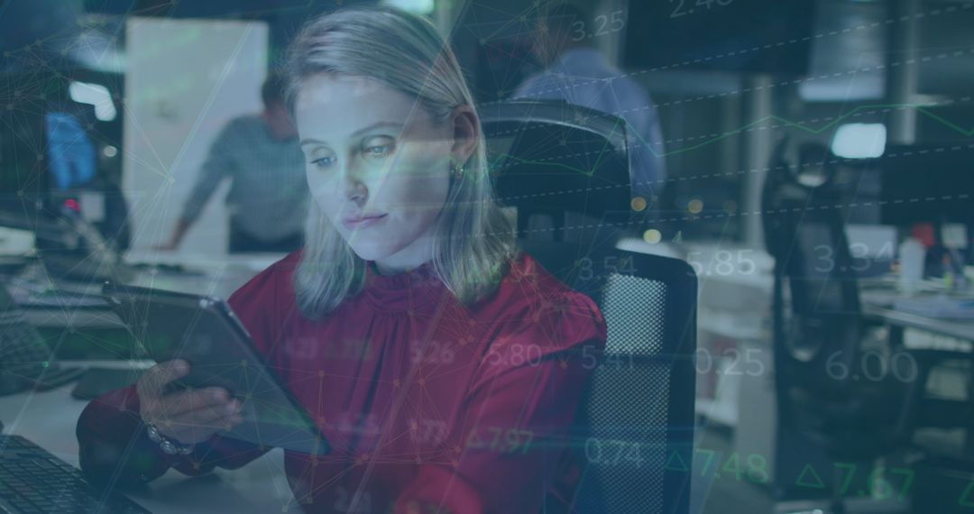 Businesswoman Analyzing Data on Tablet in Office Environment