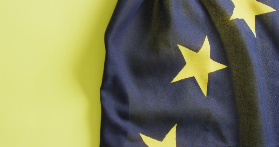 Close-Up of Flag with Yellow Stars Against Yellow Background - Free Images, Stock Photos and Pictures on Pikwizard.com