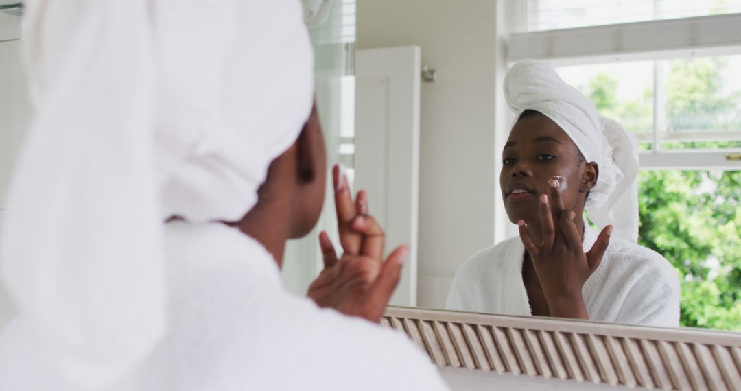 Woman Applying Skincare in Modern Bathroom - Free Images, Stock Photos and Pictures on Pikwizard.com