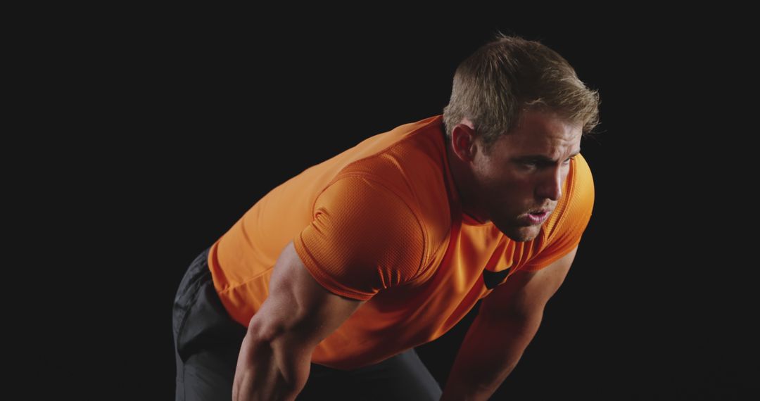 Exhausted Male Athlete After Intense Workout in Orange Shirt - Free Images, Stock Photos and Pictures on Pikwizard.com