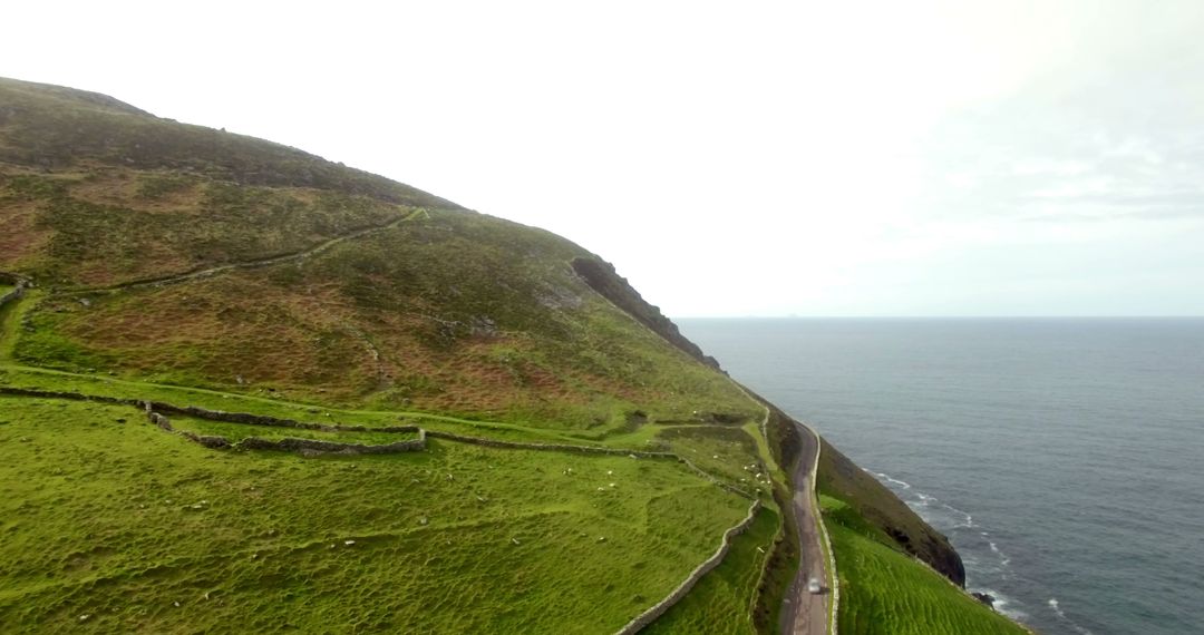Scenic View of Coastal Road Along Rolling Hills - Free Images, Stock Photos and Pictures on Pikwizard.com