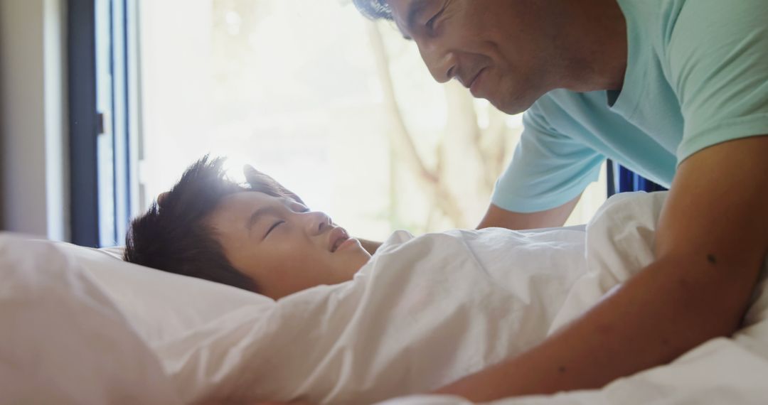 Father Waking Up Sleeping Son in Bright Morning Light - Free Images, Stock Photos and Pictures on Pikwizard.com