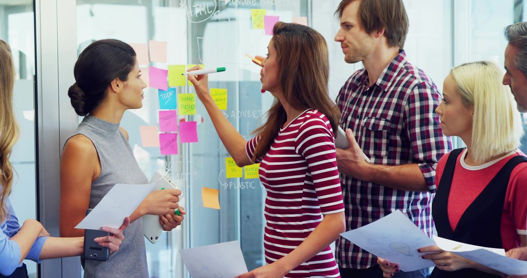 Creative team brainstorming with colorful sticky notes and marker-led ideation