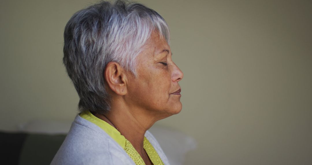 Senior Woman Meditating at Home in Peaceful Atmosphere - Free Images, Stock Photos and Pictures on Pikwizard.com