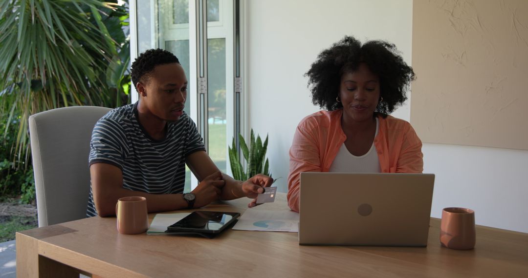 Couple Collaborating on Remote Work with Laptop at Home Office